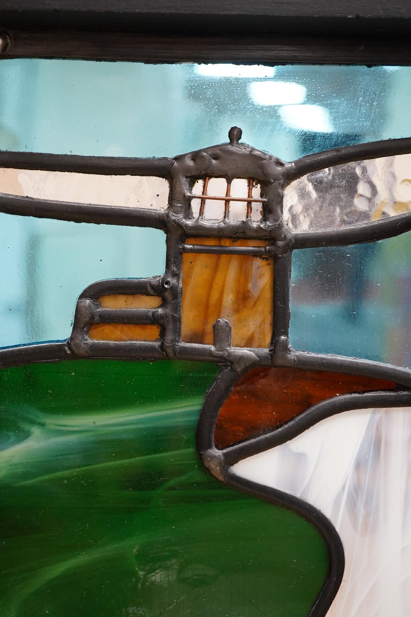 A contemporary leaded stained glass panel, Beachy Head lighthouse, framed, 51cm high overall